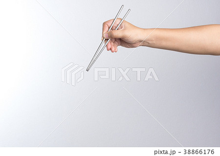 Hand holding stainless chop stick 38866176