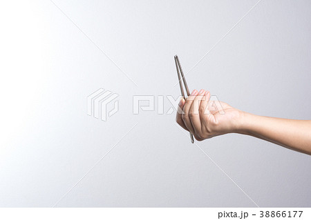 Hand holding stainless chop stick Hand holding stainless chop stick 38866177