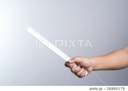 Hand holding a ruler Hand holding a ruler 38866178