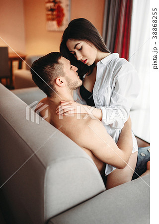 Sexy woman sitting on man, intimate games on couch Sexy woman sitting on man, intimate games on couch 38868255
