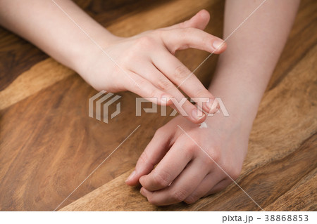teen girl applying hand cream 38868853
