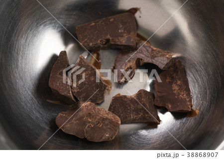 melting dark chocolate chunks in steel bowl 38868907