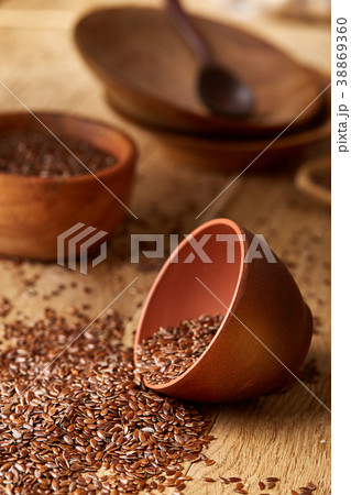 An overturned ceramic bowl with linseeds on a 38869360