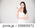Asian woman holding cosmetics makeup product 38869972