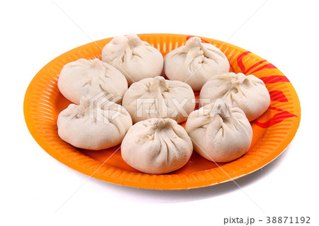 Frozen manti laying on the orange plate Frozen manti laying on the orange plate 38871192