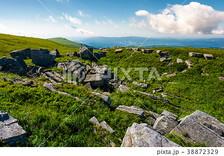 rocky formation on grassy hillside 38872329