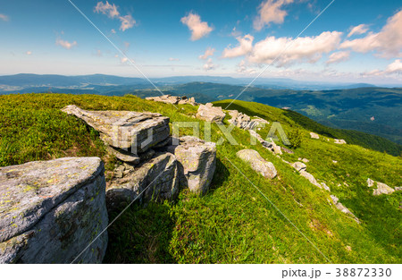 rocky formation on grassy hillside 38872330
