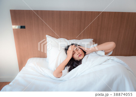 Pretty asian woman feeling headache after waked up Pretty asian woman feeling headache after waked up 38874055