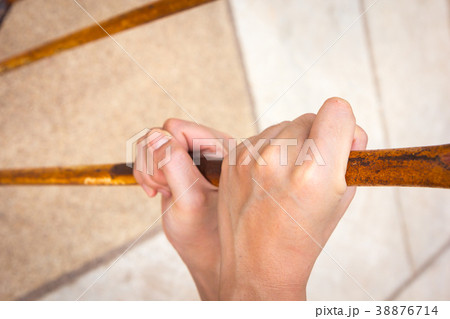 close up of hand on chain-link fence 38876714