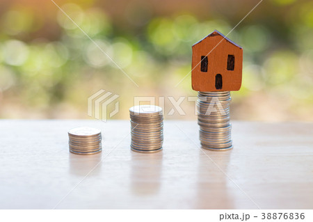 Small house with coins. Home saving concept. Small house with coins. Home saving concept. 38876836