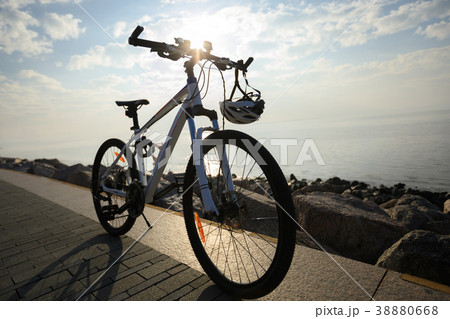 mountain bike with helmet on sunrise seaside 38880668