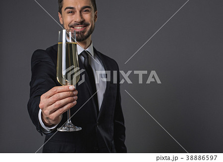 Young cheerful man proposing toast Young cheerful man proposing toast 38886597