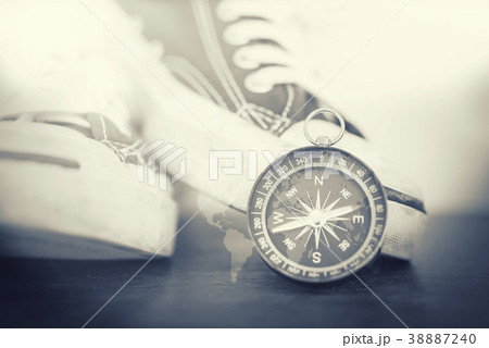 Double exposure of compass, shoes and world map. 38887240