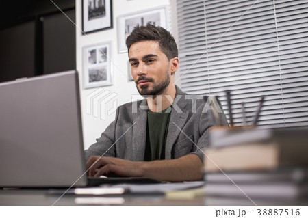 Concentrated guy working in office Concentrated guy working in office 38887516