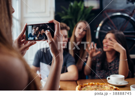 Young woman photographing her positive friends in Young woman photographing her positive friends in 38888745