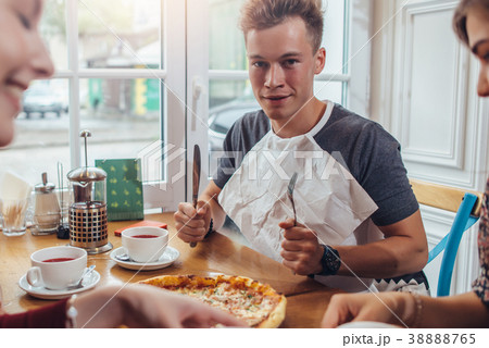 Stylish teenager wearing napkin holding knife and 38888765