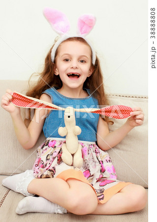 Cute little child wearing bunny ears on Easter day Cute little child wearing bunny ears on Easter day 38888808