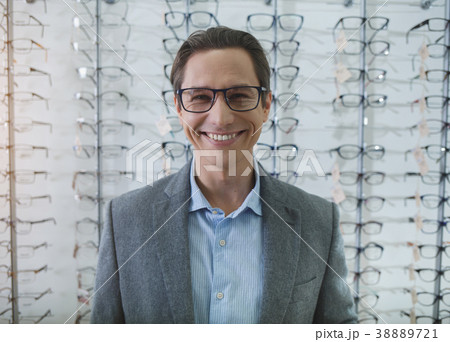 Outgoing male locating in optician store 38889721
