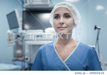 Pleasant qualified nurse standing and looking Pleasant qualified nurse standing and looking 38893616