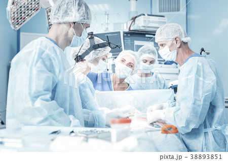 Interested worried medics standing and looking at 38893851