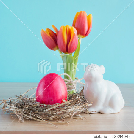 Red egg in the nest and rabbit.Easter composition. Red egg in the nest and rabbit.Easter composition. 38894042