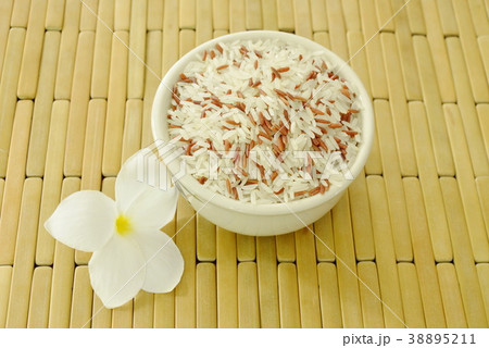 mixed red cargo paddy in bowl with temple tree  38895211