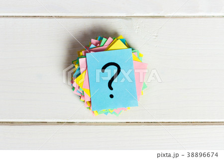 Question mark paper heap on wooden table concept Question mark paper heap on wooden table concept 38896674
