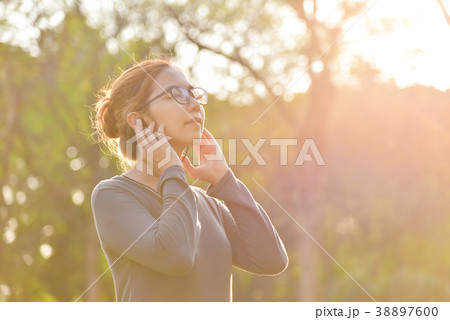 Asian woman is listening to the music. Asian woman is listening to the music. 38897600