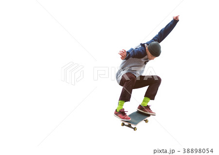 A teenager skateboarder jumps an ollie on an A teenager skateboarder jumps an ollie on an 38898054
