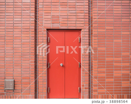 Steel Red Door on Red Brick Wall 38898564
