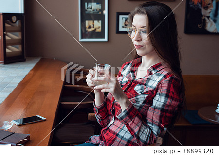 The brunette girl with glasses and a shirt, in the 38899320