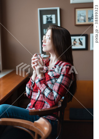 The brunette girl with glasses and a shirt, in the 38899323