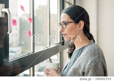 Portrait of young woman day dreaming during break Portrait of young woman day dreaming during break 38900354