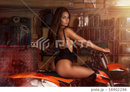 Girl sitting on motorbike 38902296