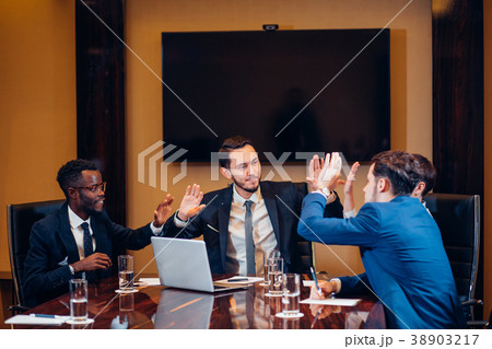 business team giving high fives gesture as they 38903217