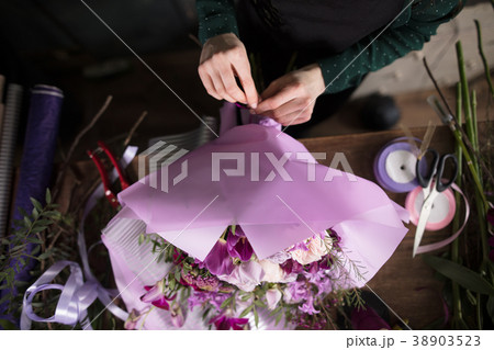 close up photo of woman's hands tying floral 38903523