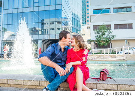 Romantic couple sitting on the bench near fountain 38903865