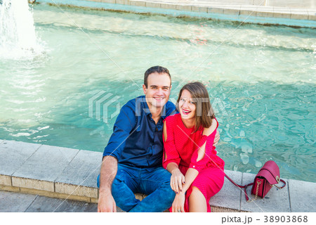 Romantic couple sitting on the bench near fountain Romantic couple sitting on the bench near fountain 38903868