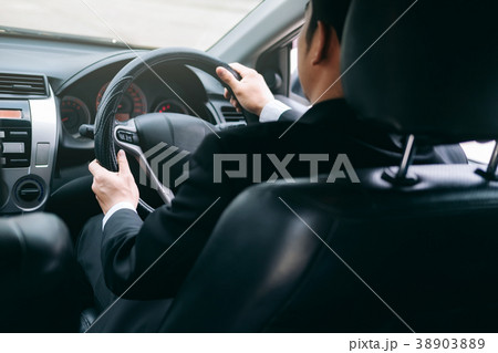 Businessman driving a car. 38903889