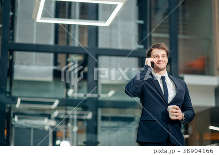 Businessman in black suit talking on phone and 38904166