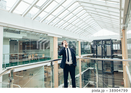 Business man walking while talking on mobile phone Business man walking while talking on mobile phone 38904799