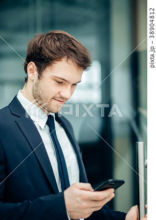 businessman with smartphone over office building businessman with smartphone over office building 38904812