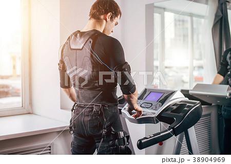 Man in black suit for ems training running on Man in black suit for ems training running on 38904969