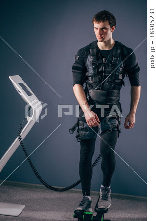 man training on stepper with electric muscle 38905231