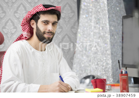 Arabian business man working on Laptop in the 38907459