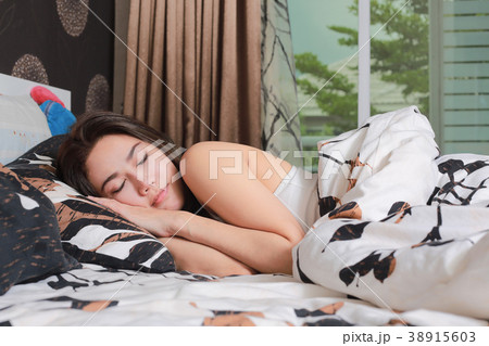 Young beautiful asian woman sleeping in her bed. Young beautiful asian woman sleeping in her bed. 38915603