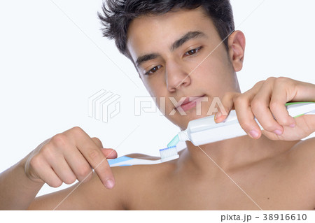 Teen boy wearing braces on white background 38916610