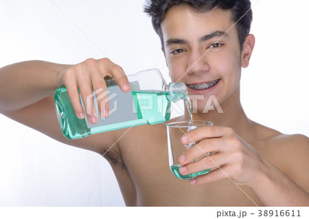 Teen boy wearing braces on white background 38916611