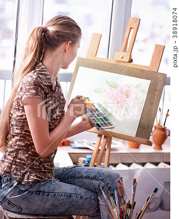 Artist painting on easel in studio. Girl paints Artist painting on easel in studio. Girl paints 38918074