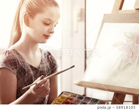 Artist painting on easel in studio. Girl paints Artist painting on easel in studio. Girl paints 38918105